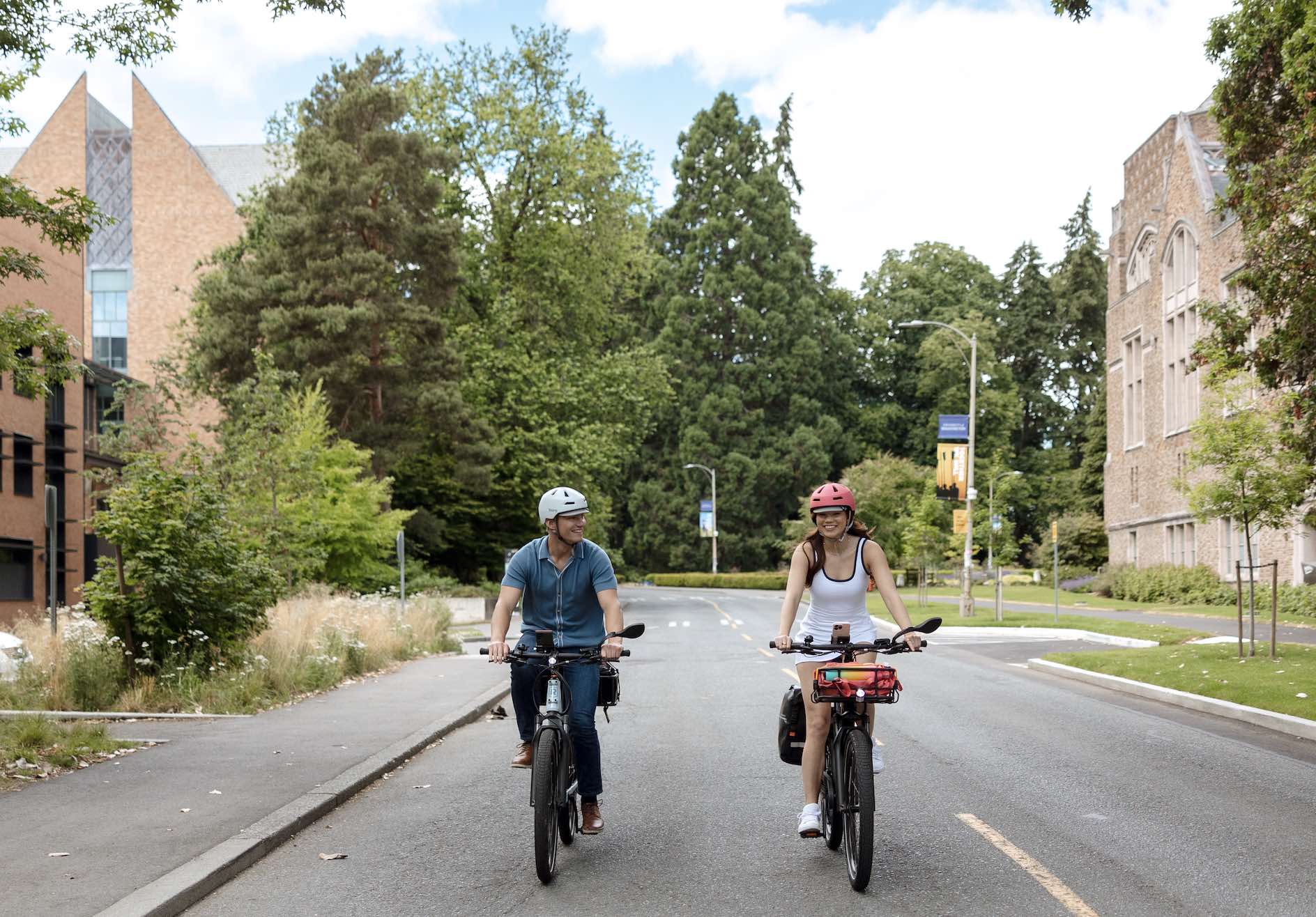 Two college students ride a RadKick ebike on campus.